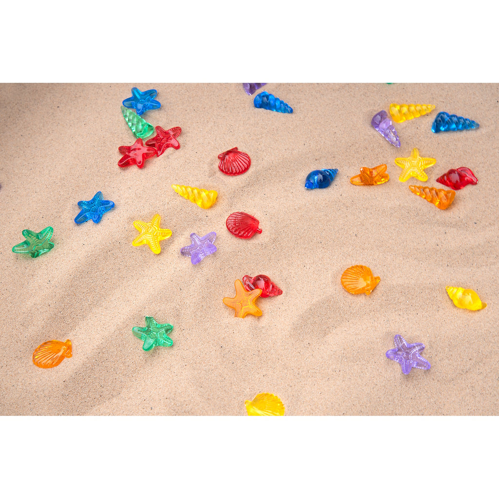 A set of vibrant, see-through plastic shells designed for sensory exploration, sorting, counting, and light-based activities.