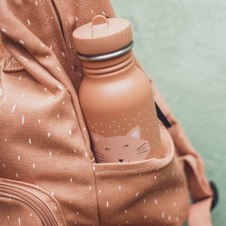 A peach-colored cat water bottle tucked inside the side pocket of a matching speckled backpack.