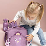 Young girl with pigtails reaching for a matching purple peacock bag, water bottle, and lunchbox.