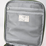 Close-up of the inside flap of a lunch bag, featuring a zippered grey mesh pocket and a name label.