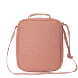 The back of a dusty pink insulated lunch bag with a white dotted pattern, top handle, and shoulder strap.