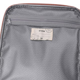 Inside of an open lunch bag showing a grey mesh zipper pocket and a Trixie name tag with a cat illustration.