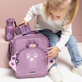 A young child sitting next to a purple peacock lunch bag, water bottle, and snack box.