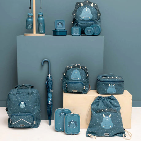 Collection of blue dinosaur-themed kids' school gear, including backpacks, lunch boxes, bottles, and an umbrella.