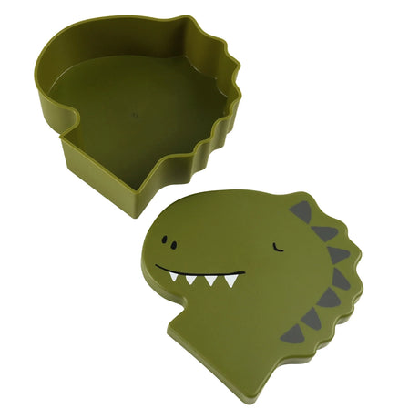 An open olive green, dinosaur-shaped lunch box next to its lid featuring a friendly cartoon dinosaur face.
