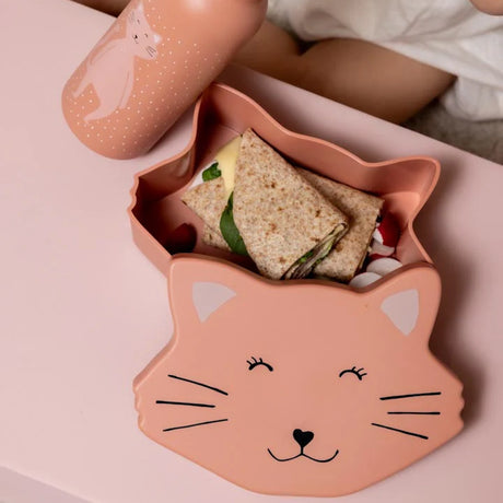Open pink cat-shaped snack box filled with wrap sandwiches next to its matching cat-themed lid and bottle.
