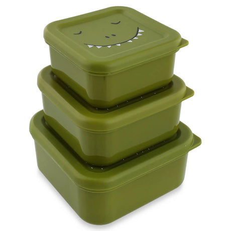 Three green square dinosaur-themed snack boxes stacked on top of each other, on a white background.