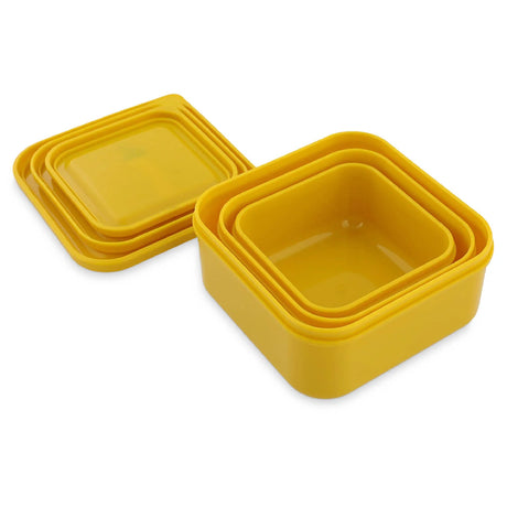 A set of three yellow kids snack boxes nested inside each other with their matching lids stacked nearby.