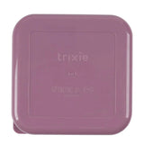 The bottom of a square, dusty pink Trixie plastic container with embossed product care icons.