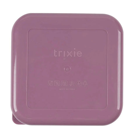 The bottom of a square, dusty pink Trixie plastic container with embossed product care icons.