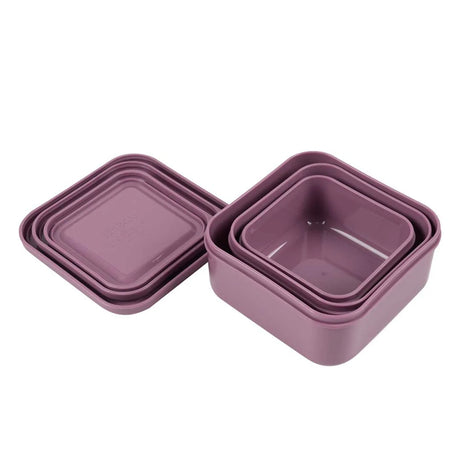 Three square purple plastic snack boxes shown open and nested inside each other, with stacked lids beside them.