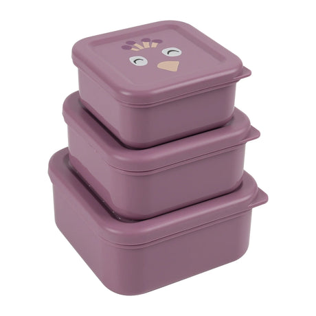 Three purple, square nesting snack boxes stacked on top of each other, with a peacock face on the top lid.