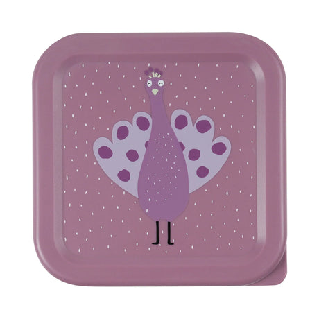 Top view of a square purple snack box lid featuring a cartoon peacock illustration against a dotted background.