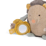 Close-up of a plush hedgehog toy with a small round mirror hidden behind a yellow fabric flap.