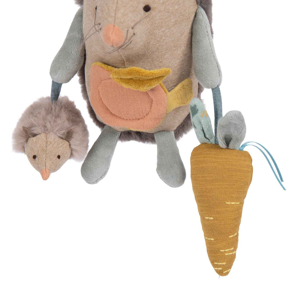 Plush hedgehog activity toy holding a small baby hedgehog and a fabric carrot against a white background.