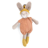 Plush rabbit toy with fuzzy ears, wearing a mustard yellow hat and socks, and a clay-colored muslin romper.