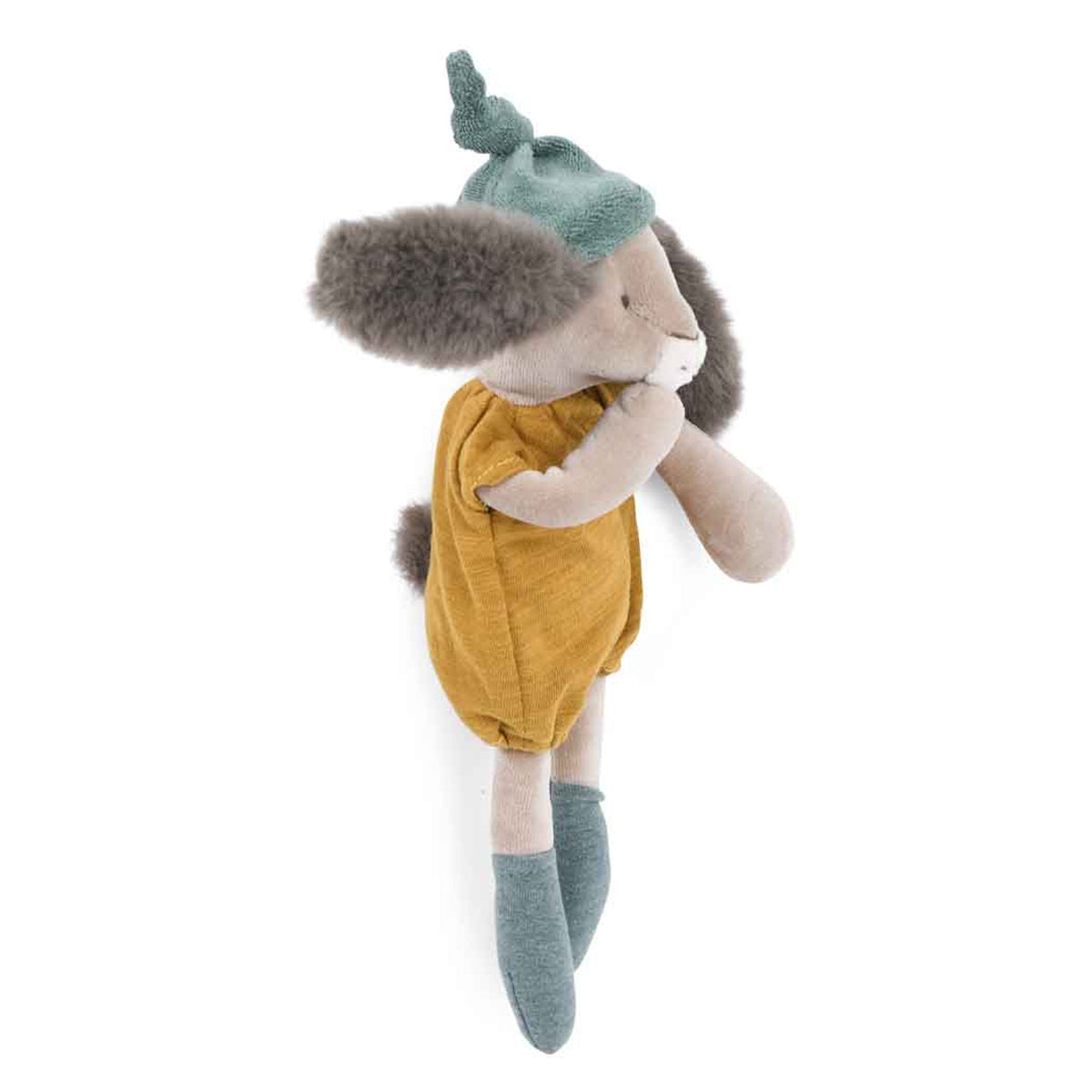 Side view of a plush rabbit wearing a green knotted hat, ochre romper, and green socks against a white background.
