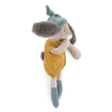 Side view of a plush rabbit wearing a green knotted hat, ochre romper, and green socks against a white background.