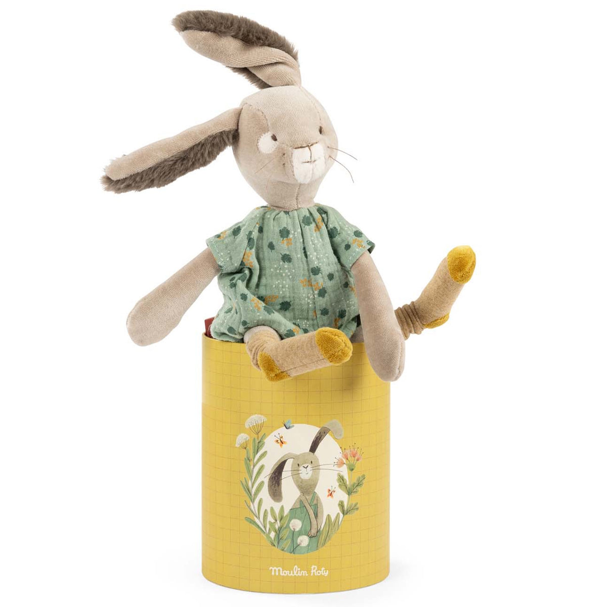 Plush rabbit with long ears and a green floral dress sitting inside a yellow illustrated cylinder box.