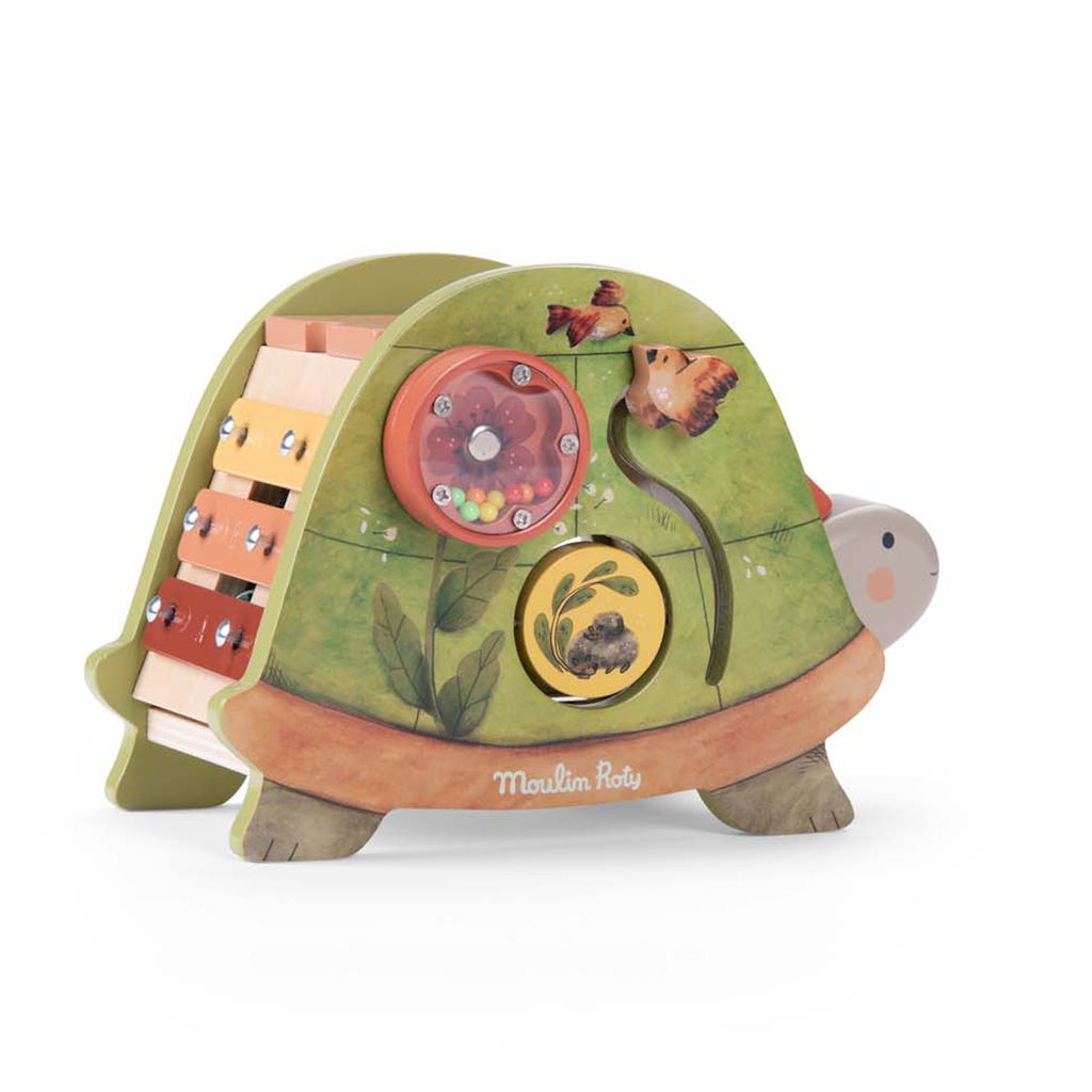 Colorful wooden activity toy featuring a xylophone with a leafy mallet, spinning gears, and nature-themed designs. Playful and educational tone.