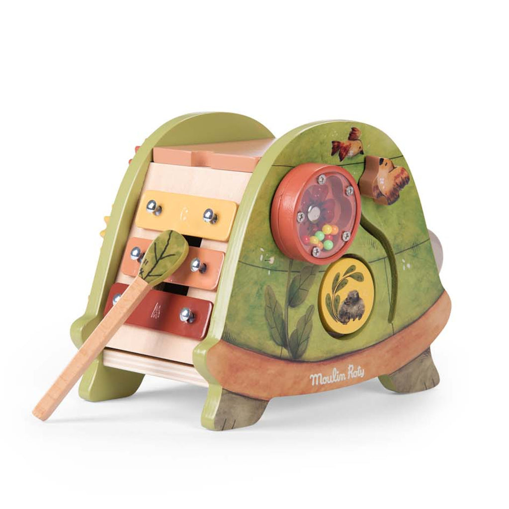 Colorful wooden activity toy featuring a xylophone with a leafy mallet, spinning gears, and nature-themed designs. Playful and educational tone.