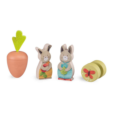 Trois Petits Lapins wooden rabbit figures, carrot toy, and butterfly shape sorter piece.