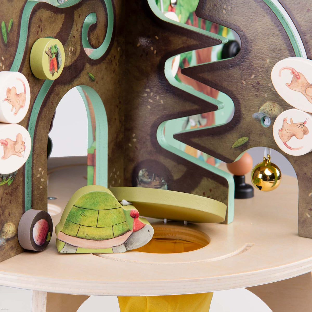 Moulin Roty wooden activity tree toy with turtle and gold bell.