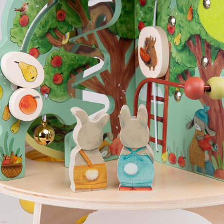 Trois Petits Lapins wooden multi activity garden toy with rabbit figures and a sliding track.