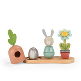 Wooden stacking toy featuring a rabbit, hedgehog, flower, and carrot on a base.