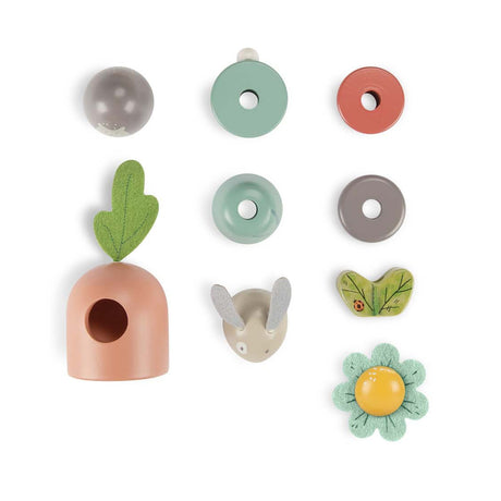 Moulin Roty Trois Petits Lapins wooden stacking toy disassembled pieces including bunny carrot and flower.
