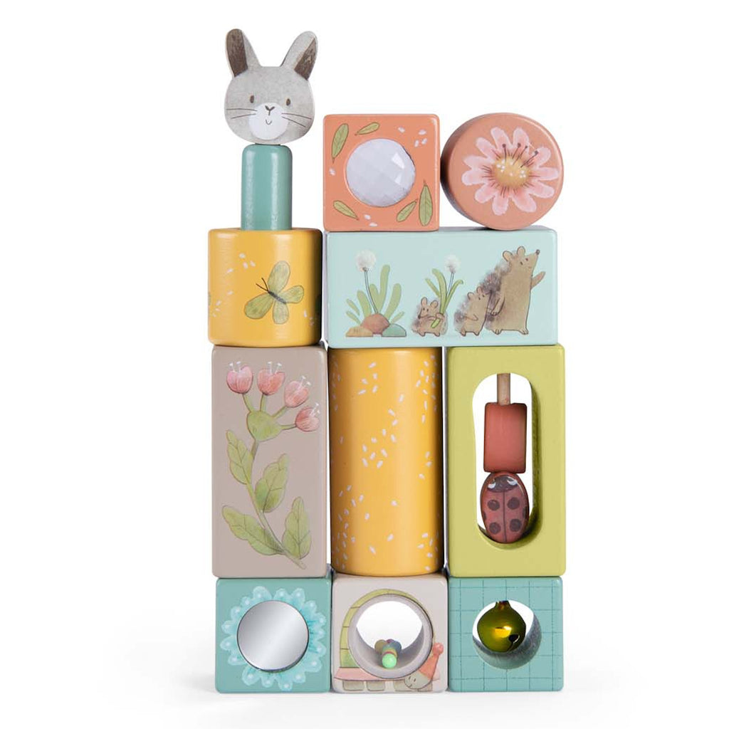 Stack of colorful wooden blocks with various designs: rabbit, flowers, butterfly, hedgehog. Playful, whimsical tone. Ideal for children's play.