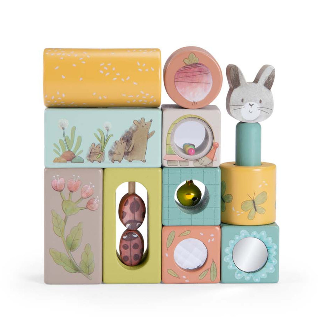 Stack of colorful wooden blocks with various designs: rabbit, flowers, butterfly, hedgehog. Playful, whimsical tone. Ideal for children's play.