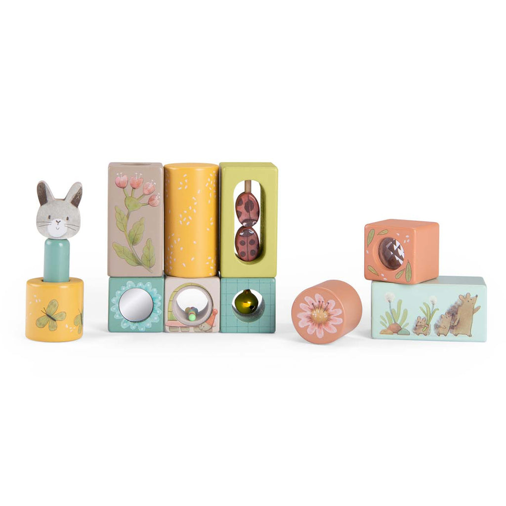 Stack of colorful wooden blocks with various designs: rabbit, flowers, butterfly, hedgehog. Playful, whimsical tone. Ideal for children's play.