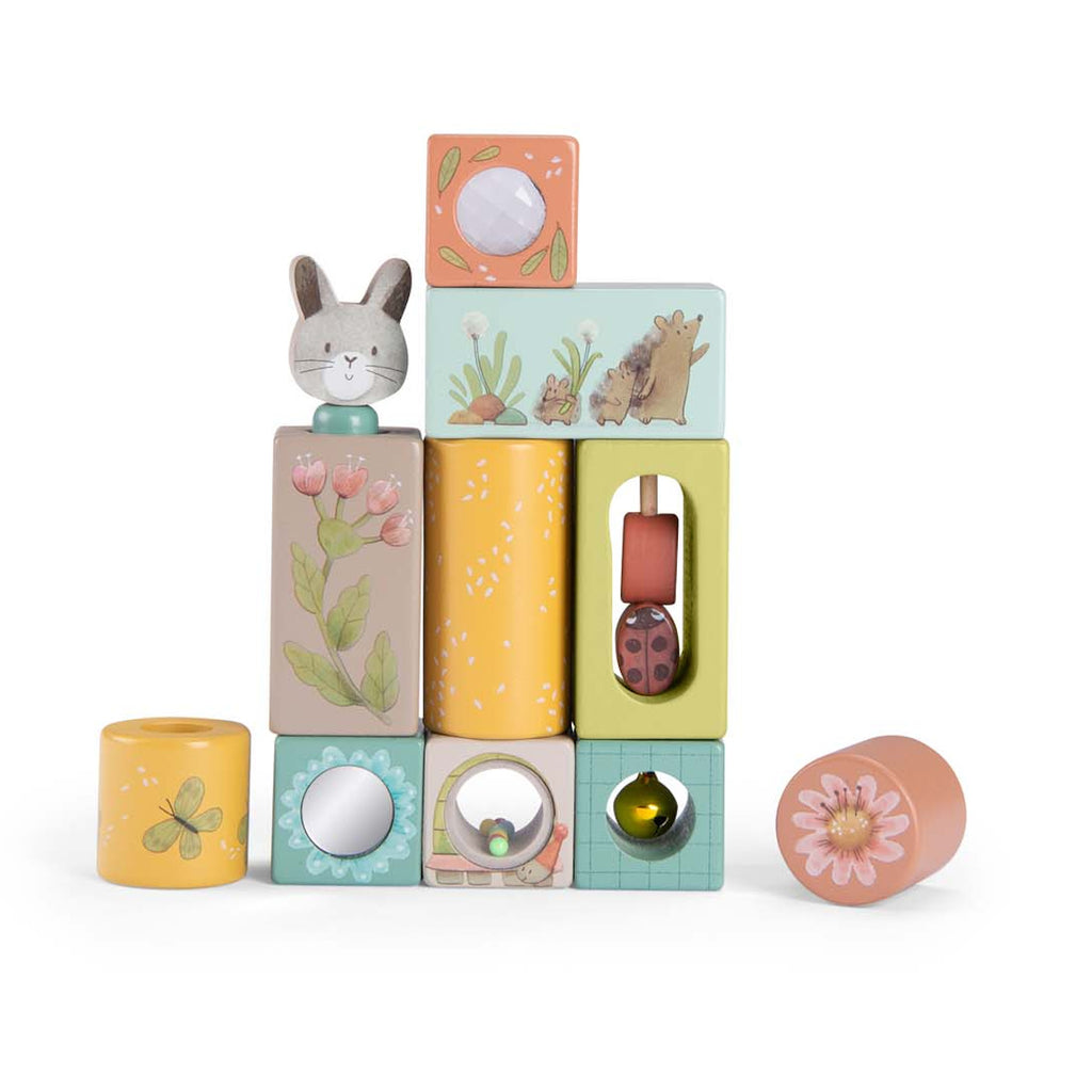 Stack of colorful wooden blocks with various designs: rabbit, flowers, butterfly, hedgehog. Playful, whimsical tone. Ideal for children's play.
