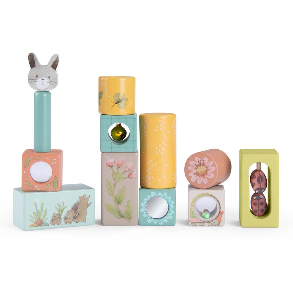 Stack of colorful wooden blocks with various designs: rabbit, flowers, butterfly, hedgehog. Playful, whimsical tone. Ideal for children's play.