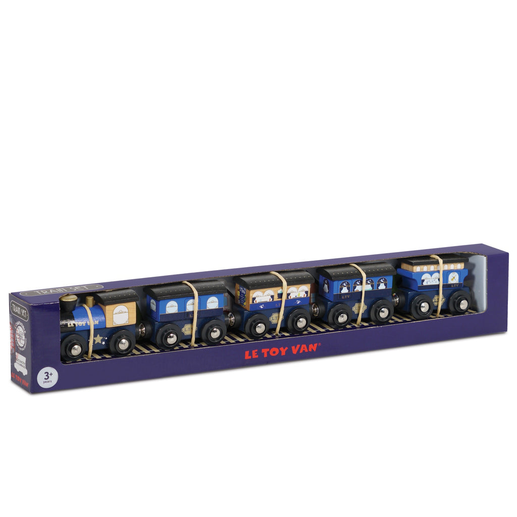 Boxed set of wooden toy train carriages in blue and yellow with windows and wheels, displayed in purple packaging, labeled "Le Toy Van."