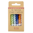 A set of colorful twisted cake candles in blue, green, yellow, orange, and white are visible through a cardboard box with "12 Twisted Cake Candles" text.
