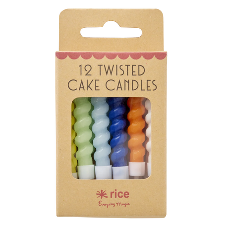 A set of colorful twisted cake candles in blue, green, yellow, orange, and white are visible through a cardboard box with "12 Twisted Cake Candles" text.