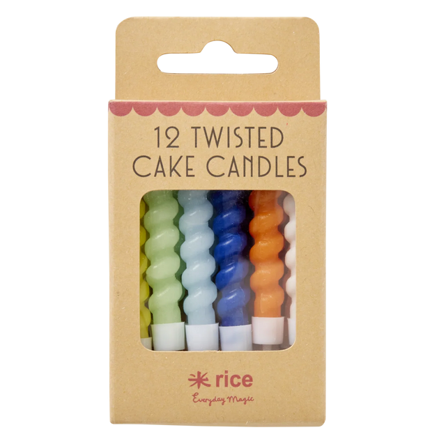 A set of colorful twisted cake candles in blue, green, yellow, orange, and white are visible through a cardboard box with "12 Twisted Cake Candles" text.