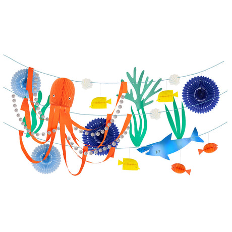 Under the sea garland with paper cutouts of an orange octopus, blue shark, yellow fish, seaweed, and shell details.