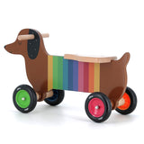Vilac rainbow dachshund wooden ride-on toy for toddlers with colorful wheels and easy-grip handles on a white background.