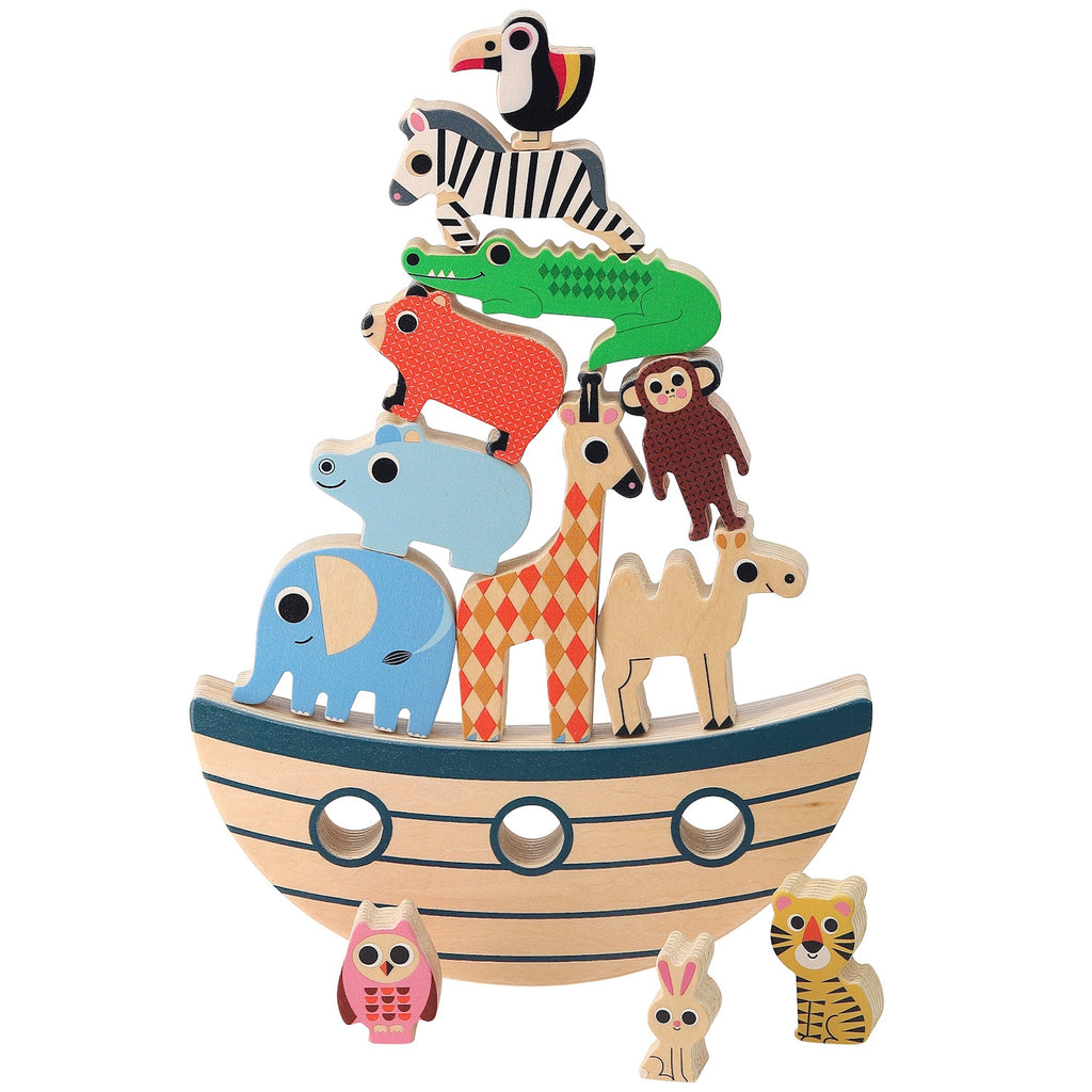 Wooden animal toys, including a toucan, zebra, and crocodile, stack on a curved base resembling a boat. An owl, rabbit, and tiger stand nearby. Playful and colorful.