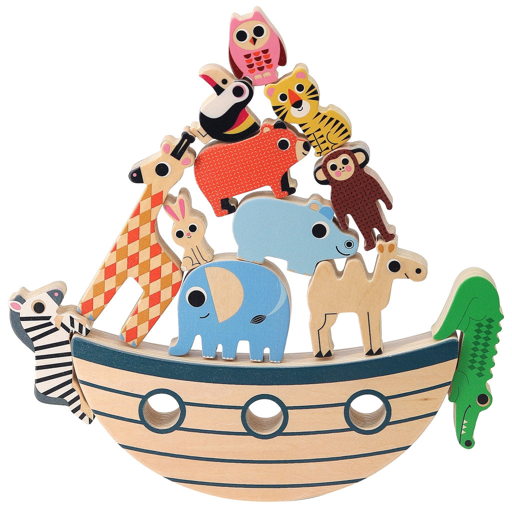 Wooden animal toys, including a toucan, zebra, and crocodile, stack on a curved base resembling a boat. An owl, rabbit, and tiger stand nearby. Playful and colorful.