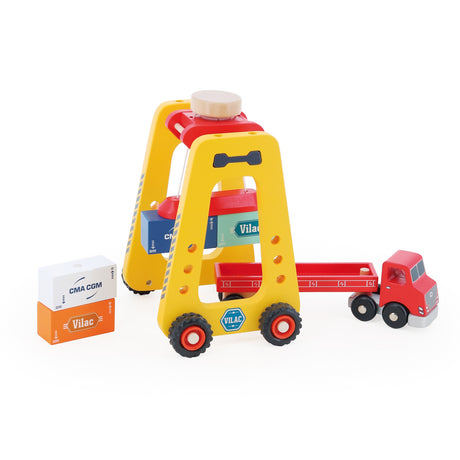 Wooden Vilac toy container crane hoisting a blue block next to a red toy truck with CMA CGM cargo blocks.