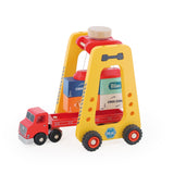 Vilac wooden container gantry crane toy loading colorful cargo blocks onto a red toy semi truck trailer.