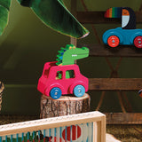 Vilac wooden crocodile toy car on a tree stump with a toucan toy vehicle in the background.