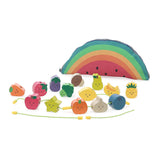 Wooden fruit and vegetable lacing beads with smiling faces next to a rainbow watermelon bag.