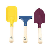 Vilac kids garden tool set featuring a yellow square shovel, a blue rake, and a purple pointed trowel.