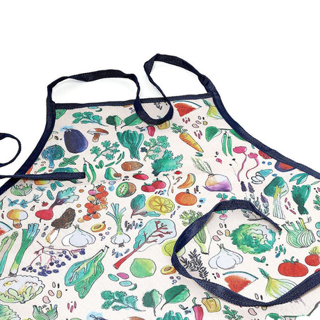 Childrens gardening apron with a colorful vegetable print, front pocket, and dark blue trim.