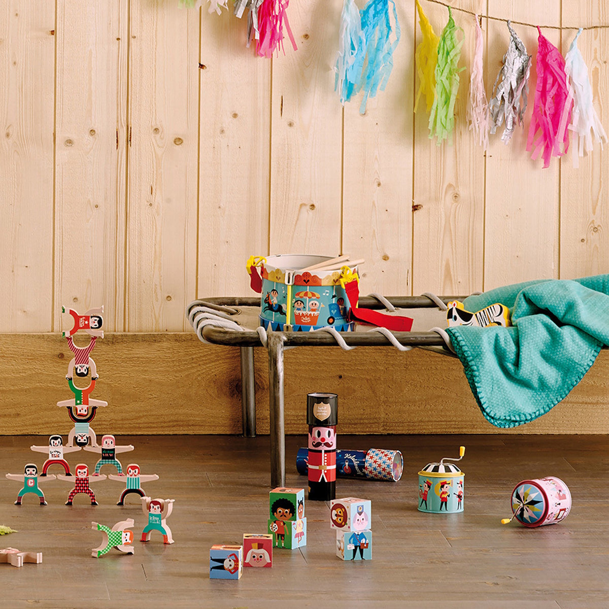 Various Vilac toys displayed in a children's room setup featuring a wooden wall and floor.
